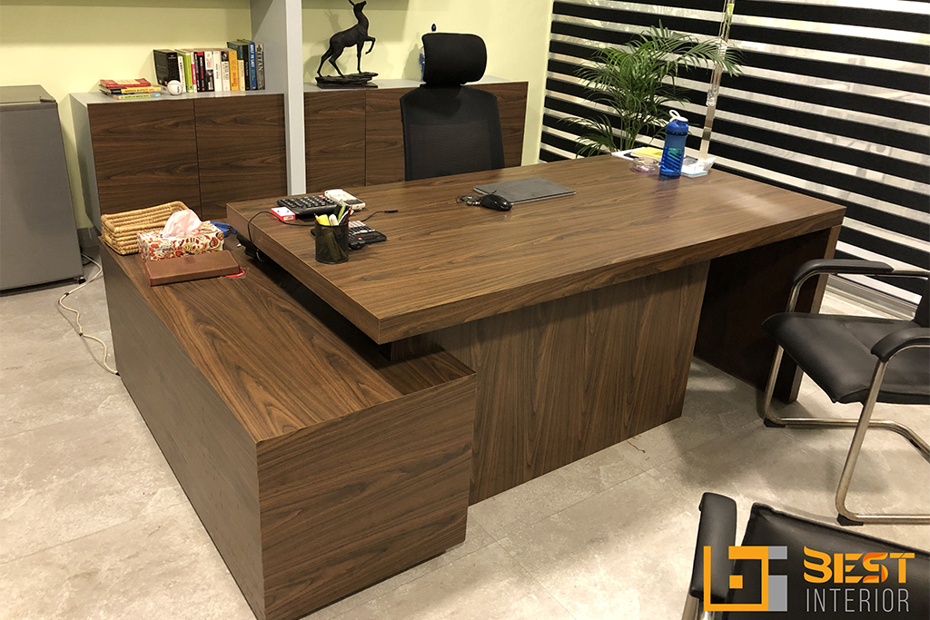 Modern executive office with walnut L-shaped desk, ergonomic chair, and storage cabinets by Best Interior