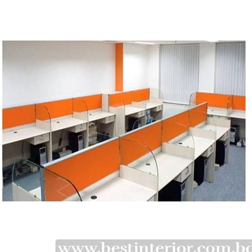 Office workstation with orange partition and glass screen.