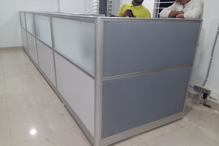Office partition cubicle with gray and white panels and aluminum frame.