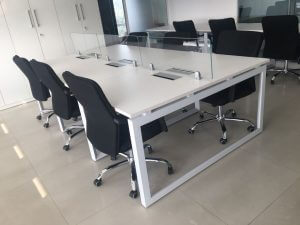 Face-to-face seating workstation with glass partitions, wire management, and MS square frame legs with powder coating.