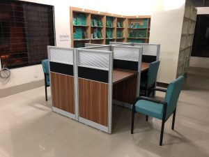 Face-to-face seating workstation with aluminium frame and plywood, used in a library.
