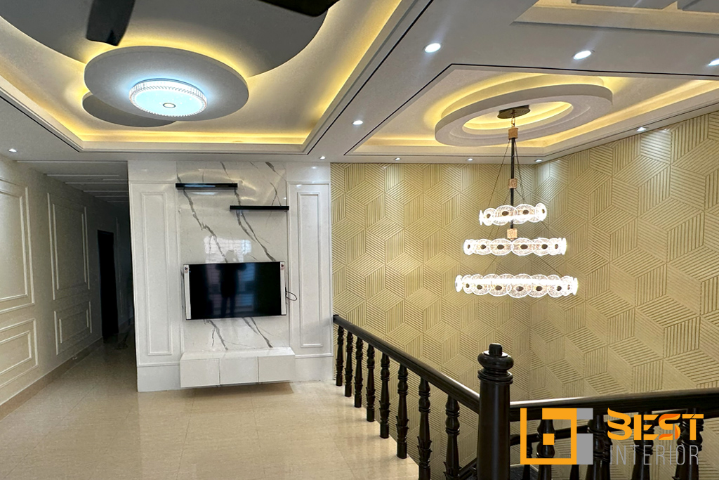 Living area with an illusion wall design, stylish staircase, and a chandelier hanging above the stairs.