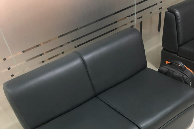 Sleek black leather office sofa with a modern design, suitable for business lounges or reception areas.