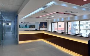 Modern office reception with Thailand Visa Application Center branding, showcasing sleek design with illuminated counter and large windows.