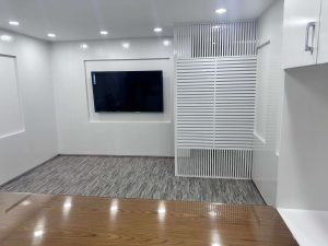 The layout has smart storage options. It includes built-in cabinets and shelves