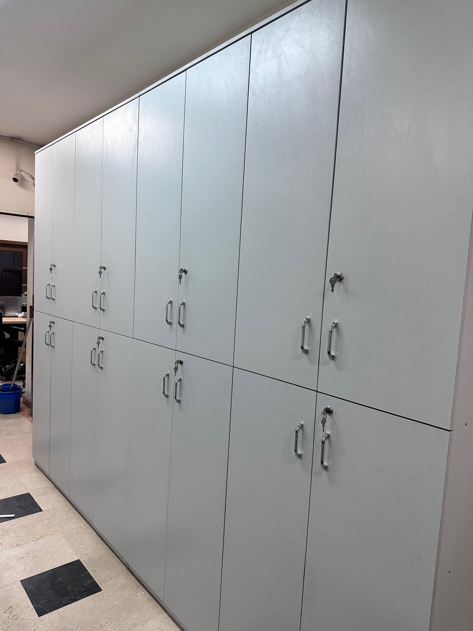 Full-height storage cabinet with multiple compartments and locking doors for secure storage.