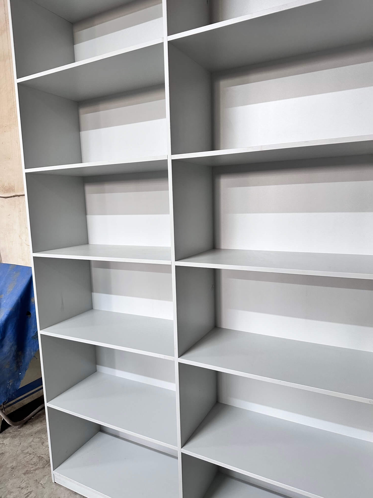 Full-height open storage cabinet with multiple shelves, designed for easy access and organization.