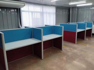 Face-to-face office cubicle workstation featuring two-tone fabric partitions and an aluminum frame, designed for collaborative workspaces.